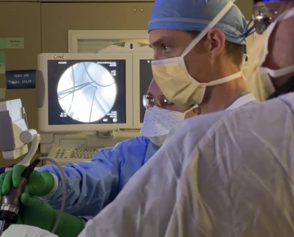 Dr. Mitchell performing knee surgery with fluoroscopic guidance